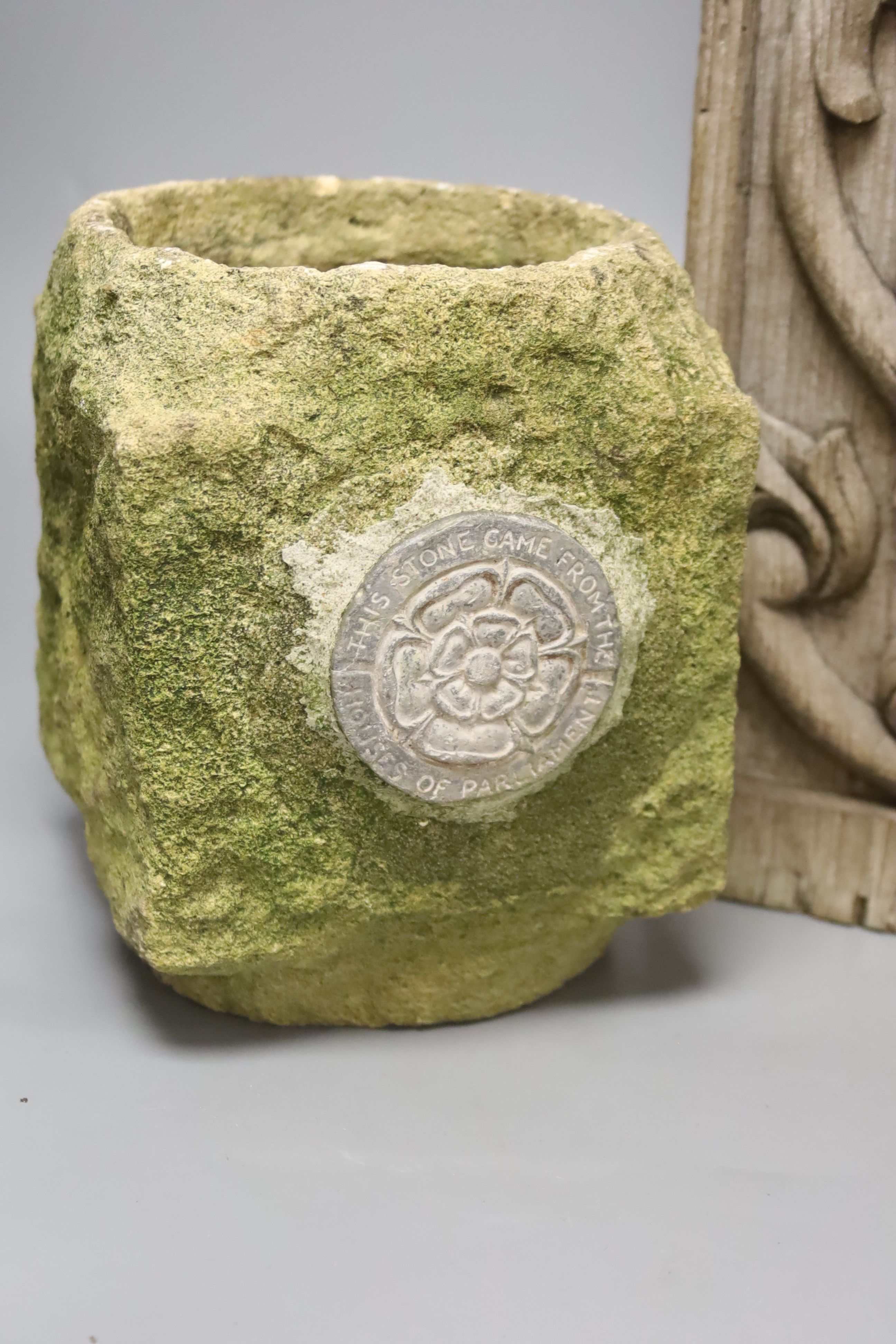A sculpted stone pot labelled This Stone came from The Houses of Parliament, 15 x 15cm 19cm high, a teak architectural support, 18th century